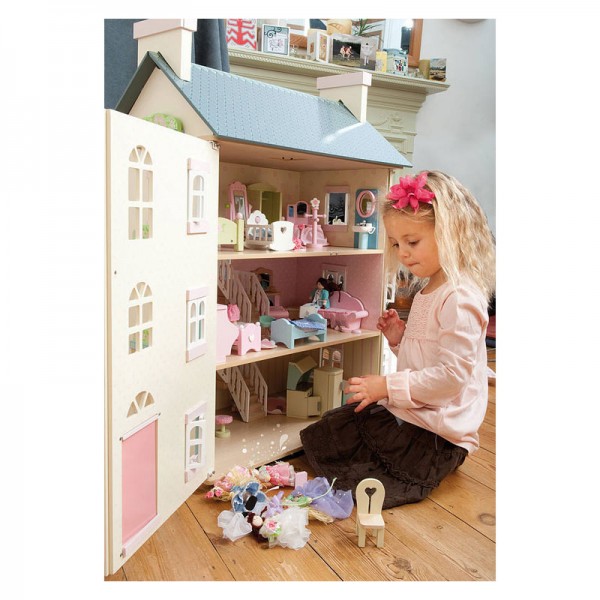 Tall dolls house with girl playing